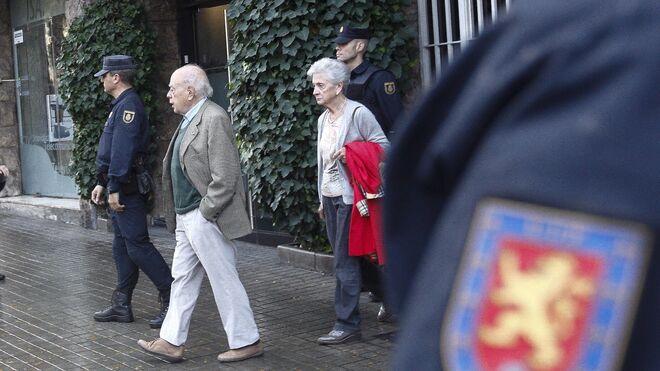 Jordi Pujol y Marta Ferrusola salen de su domicilio durante los registros de esta mañana.