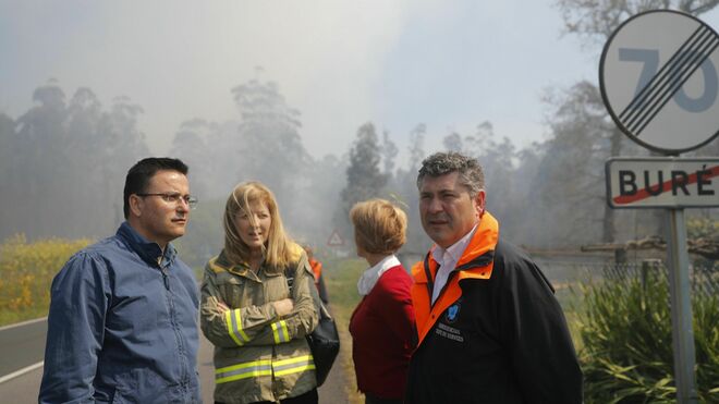 El delegado de la Xunta, Ovidio Rodeiro (d) y el conselleiro de Medio Rural, José González (i) siguen las labores de extinción en el incendio en la localidad coruñesa de Rianxo.