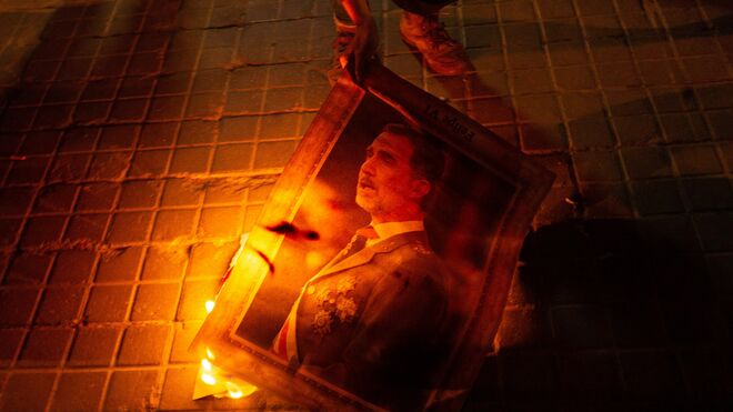 Decenas de manifestantes han quemado fotos del rey en una protesta en las inmediaciones del Palacio de Congresos de Barcelona.