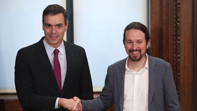 El presidente del Gobierno en funciones, Pedro Sánchez  y el secretario general de Podemos, Pablo Iglesias, se dan la mano durante la presentación del programa de Gobierno del PSOE y Unidas Podemos.