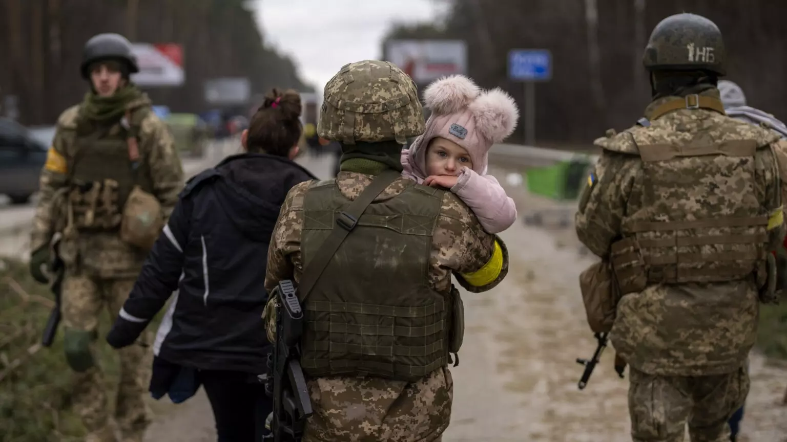 Un soldado ucraniano sostiene a un bebé para cruzar el río de Irpin (Kyiv, Ukraine) (Gtres/ AP Photo/Emilio Morenatti)