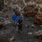 Residents walk in destroyed Bucha