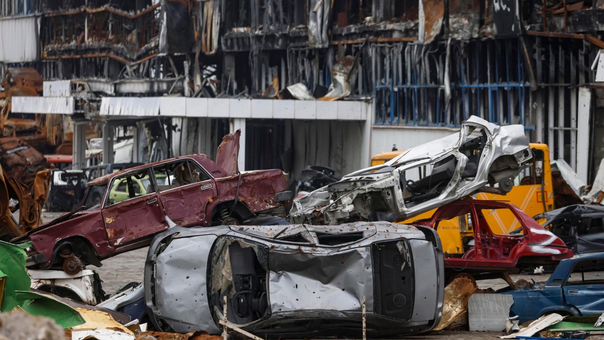 Vehículos destrozados apilados cerca de un centro comercial destruido durante un combate en Mariúpol