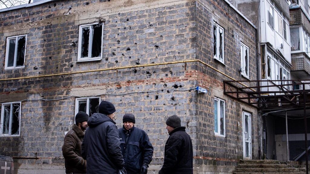 Vecinos de Avdiivka hablan en una fría mañana de invierno. A pocos metros cayó un proyectil el día anterior.