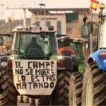 Un tractor con una pancarta en las protestas de los agricultores