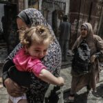 Una mujer palestina sostiene a un niño en una foto de archivo.